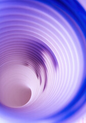 Overhead shot of blue coiled paper creating an abstract tunnel effect