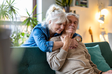 Portrait of a happy senior couple sitting on sofa at home
- 762349746