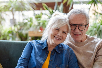 Portrait of a happy senior couple sitting on sofa at home
- 762349799
