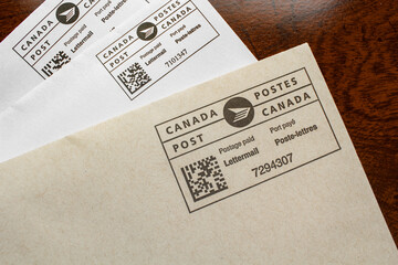 Pleasant Valley, Canada - March 15, 2024: Canada Post postage paid envelopes. Canada Post is a Crown corporation and is Canada's primary postal service.
