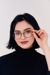 Smiling Brunette Woman Wearing Eyeglasses Poses on White Background