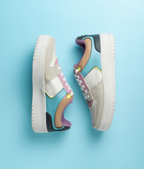 Colorful sneakers on a blue background. Flat lay, top view