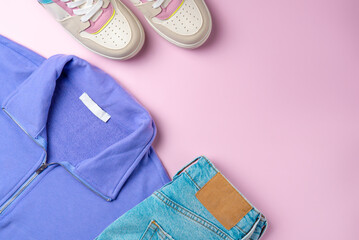 Outfit for teenagers on a pink background. Casual street style, top view point, flat lay.