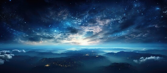 A stunning natural landscape at night, with a sky full of stars and majestic mountains in the foreground. Cumulus clouds drift across the horizon, adding to the peaceful atmosphere of the scene - obrazy, fototapety, plakaty