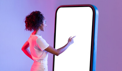Black lady interacting with large smartphone screen on gradient backdrop
