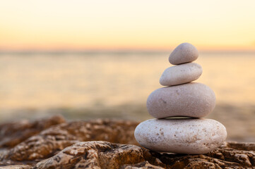 Pile of Stones on Tranquil Beach at Sunset - 762366762