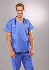Poster Man, nurse and portrait in studio, medical expert and specialist on gray background. Happy male person, cardiologist and proud of choice or decision on medicare, trustworthy physician and health © peopleimages.com