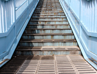 Stairs of the overhead pedestrian crossing. Pedestrian bridge. Overpass stairs in a city.