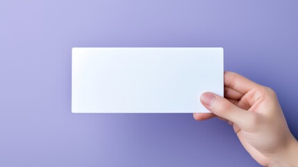 Hand is holding blank white card on a purple. Woman holding blank business card on violet background