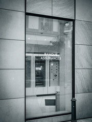 Generic french europe bank branch with the text 'Bank and Insurance' in French, with its glass shattered following a protest in France, highlighting the aftermath of the demonstration - blue colro