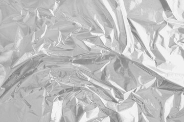 Shiny silver foil texture background, pattern of wrapping paper with crumpled and wavy.