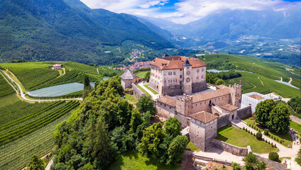 Medieval beautiful castles of northern Italy - splendid Thun castel amongst the apple trees of Val di Non. Trentino region, Trento province. Aerial drone panoramic view - 762372399