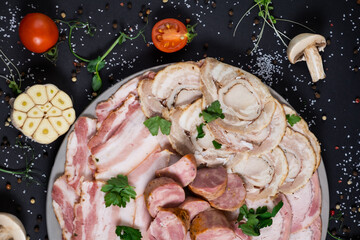 Cured meat platter of traditional Spanish tapas. Chorizo, jamon serrano, lomo and fuet. Black...