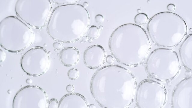 Motion of molecule bubbles in a cosmetic serum, macro. Transparent cosmetic gel fluid with molecule bubbles. Macro shot of natural organic cosmetics, health care , medicine. Slow Motion