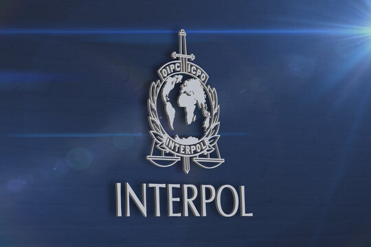 Image of the Interpol sign on a blue wall background; Austria, Vienna, January 26, 2024.