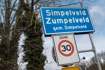Place name sign Simpelveld Limburg Netherlands. Zuid Limburg. Zumpelveld. Traffic sign 30 kilometer zone.