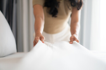 Housewife set up white sheet and cleaning in room. Housewife - obrazy, fototapety, plakaty