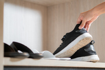 Girl puts on sneakers after returning from a walk at the closet