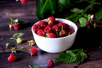 hot raspberry tea in two transparent cups on a stone table. Fresh berries, cubes of cane sugar and a bag of tea