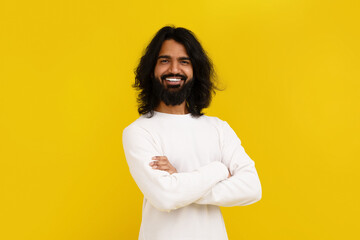Confident indian guy posing with arms crossed on chest