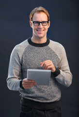 Man, glasses and tablet in studio with smile for portrait, connection or contact by dark...