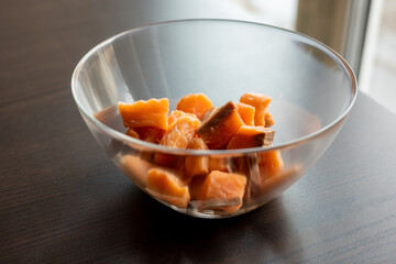  Close-up of raw fresh salmon fillets cut into cubes and presented in a glass bowl, highlighting their freshness and texture