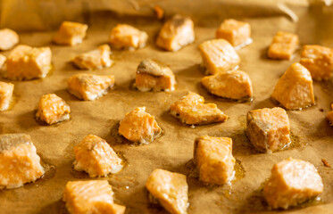 cooked salmon cubes on parchment paper