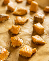 cooked salmon cubes on parchment paper