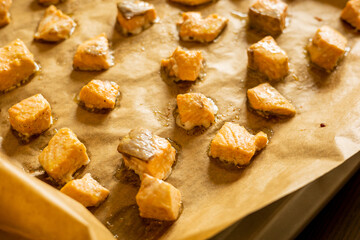 cooked salmon cubes on parchment paper