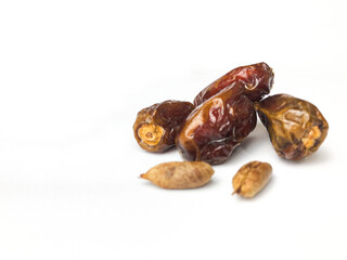 Dates and date seeds on a white background.