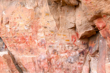 Colourful animal rockpaintings and handprints on rock walls at Cueva de las Manos, UNESCO World Heritage Site, Patagonia, Argentina