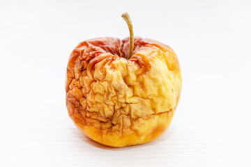 old flabby rotten apple on a white background