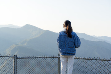 Woman stand at the top mountain in countryside - 762411746