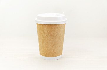 Disposable paper craft coffee cup on white background.