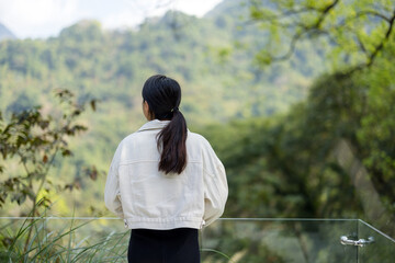 Woman enjoy the green lush scenery view - 762412152