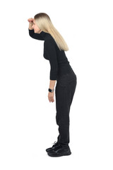 side view of standing woman look away with hand on forehead on white background