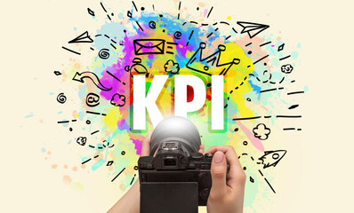 Close-up of a hand holding digital camera with abstract drawing