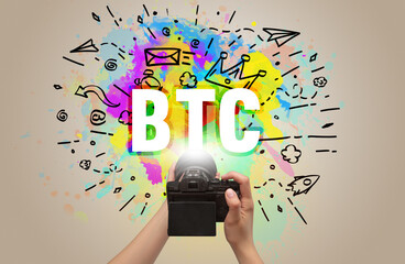 Close-up of a hand holding digital camera with abstract drawing