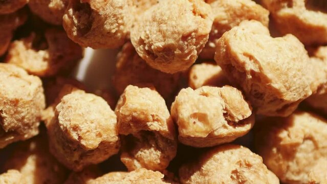 Dehydrated soy texture. Vegan meat. Food background. Rotated video	