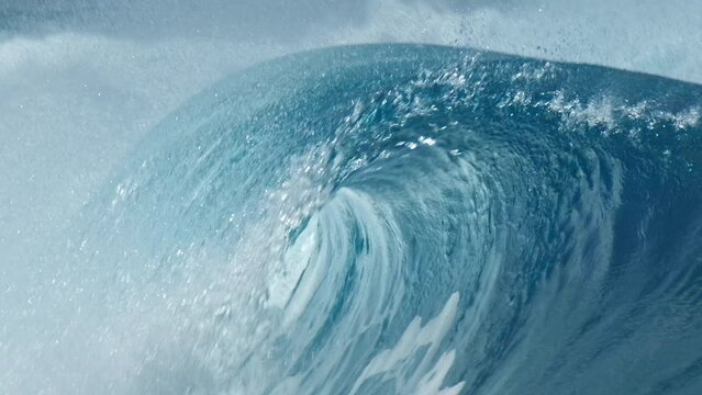 Perfect blue ocean wave breaks on the shore in the Maldives. Honeymoon surfing spot near the island of Himmafushi