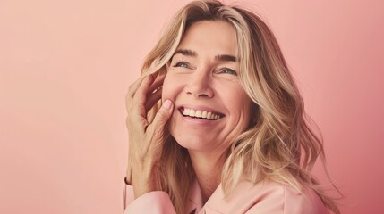 Obraz premium A woman with blonde hair and a pink shirt is smiling