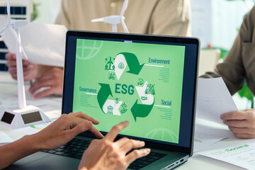 ESG ( environment, social,governance) recycle sign on laptop screen with carbon free chart board in office - 762435530