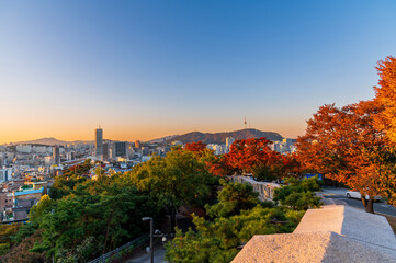 Sunset of Seoul cityscape with high rise office buildings and skyscrapers and cityFortress wall of...