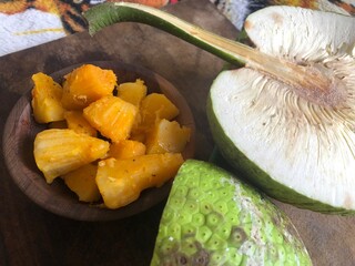 cooked breadfruit served in wooden bowl with copy space
