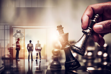 double exposure of chess piece on chess board game with silhouette business team and strategy, business success concept, business competition planning teamwork strategic concept.
- 762448319