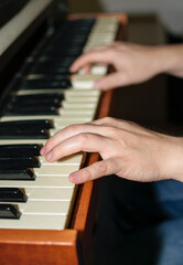 Close up view of Caucasian hands playing electric piano in bedroom