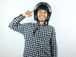 Portrait Asian man holding motorcycle helmet with excited expression. Safety riding.