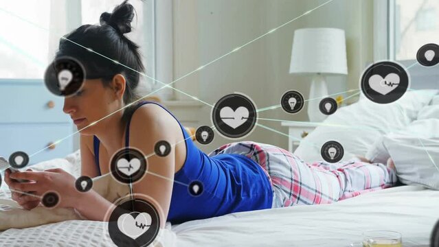 Animation of network of connections with heart icons over caucasian woman using smartphone