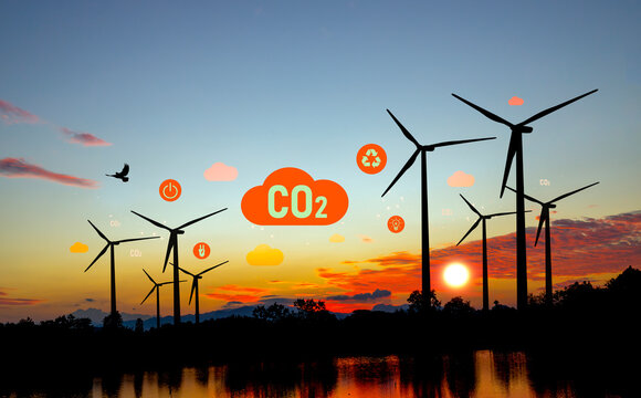 Carbon Neutrality and Net Zero concept. green net center icon in hand, sunset background