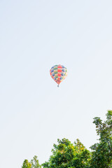 Hot air balloons landing in a mountain flight over field and forest,colorful Hot air balloons flying over the valley with blue sky,Tourism concept.